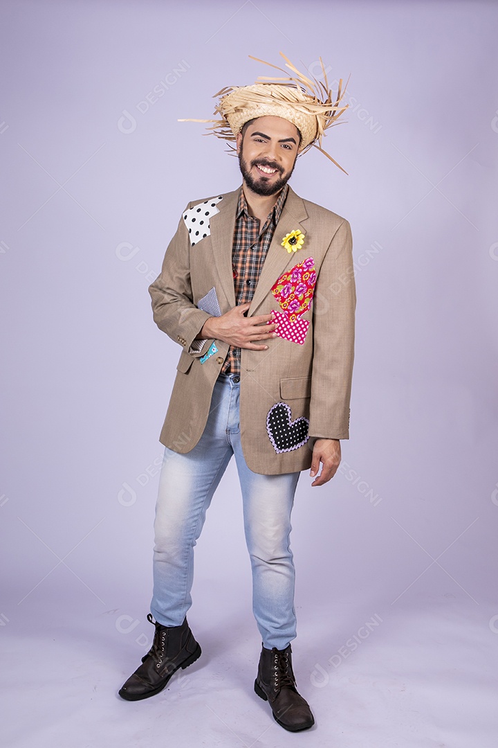 Jovem rapaz trajado para festa junina sorrindo com mão no peito