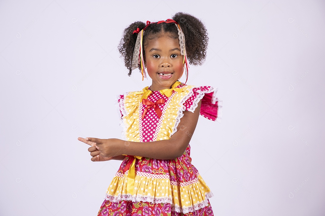 Quadrilheira mirim trajada e apontando para o lado