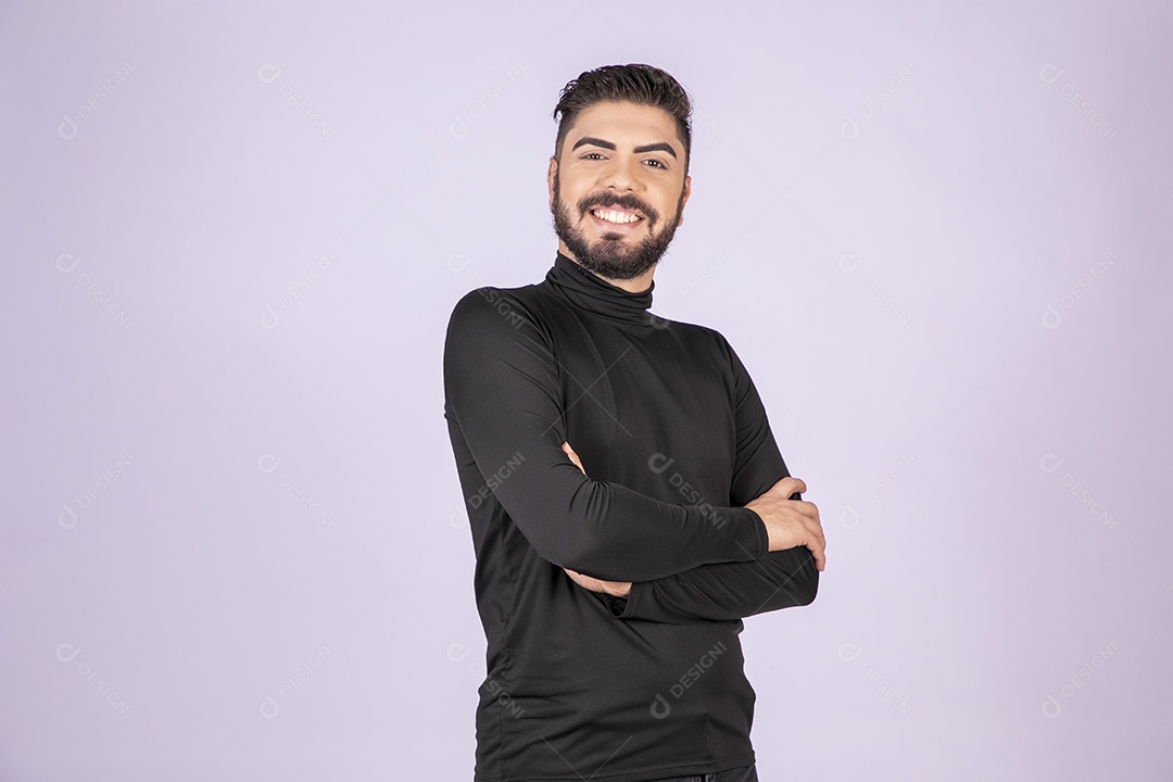 Jovem homem com braços cruzados sorrindo