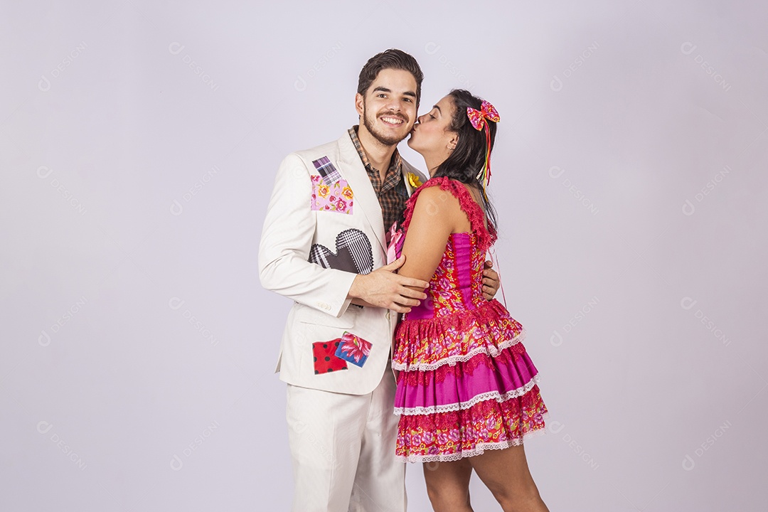 Casal a caráter para festa de São João abraçados beijando