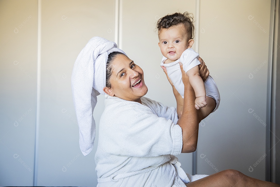 Mãe dedicada e carinhosa segurando seu bebê feliz