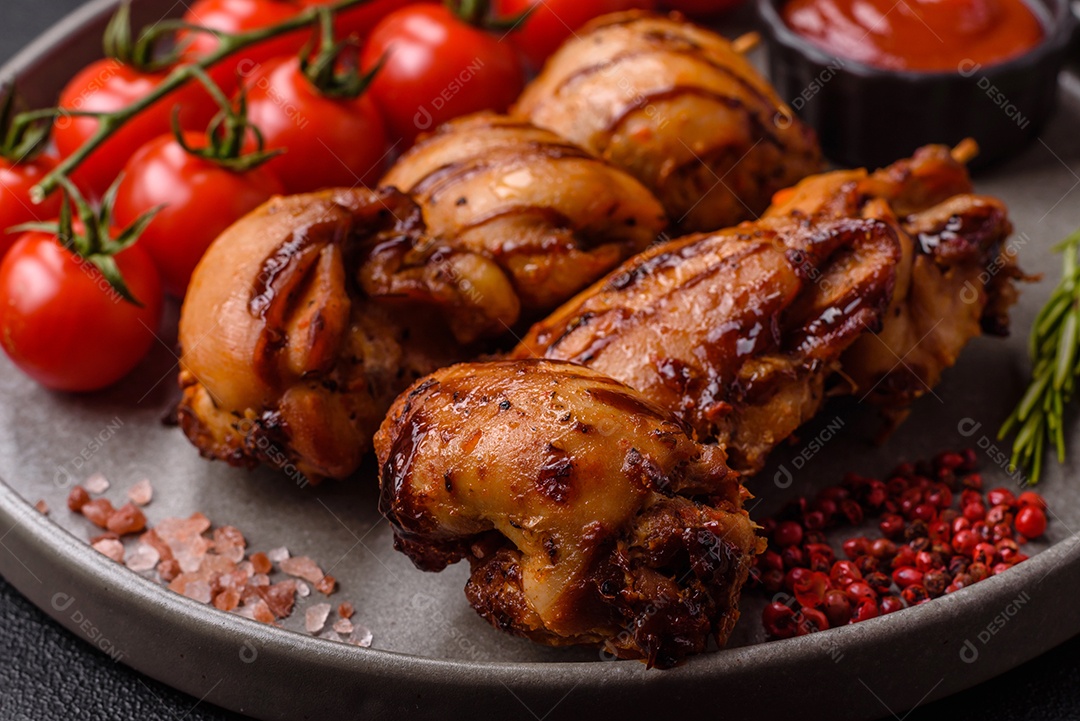 Delicioso frango assado ou espetinho de peru em um espeto com sal e especiarias em um fundo escuro de concreto