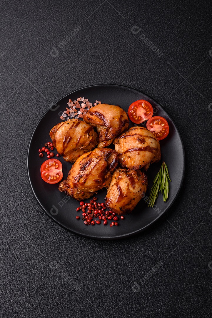 Delicioso frango assado ou espetinho de peru em um espeto com sal e especiarias em um fundo escuro de concreto
