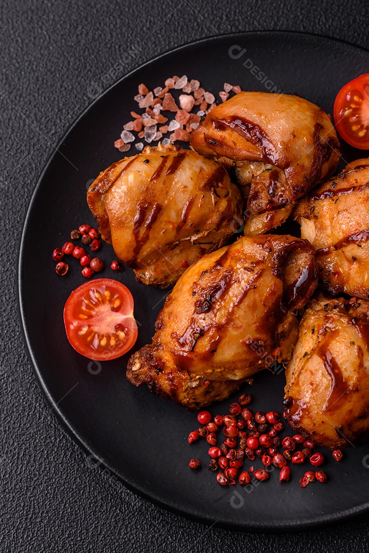 Delicioso frango assado ou espetinho de peru em um espeto com sal e especiarias em um fundo escuro de concreto