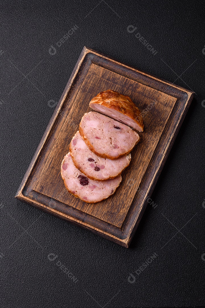 Bolo de carne defumado ou salsicha com sal, especiarias e ervas sobre um fundo escuro de concreto
