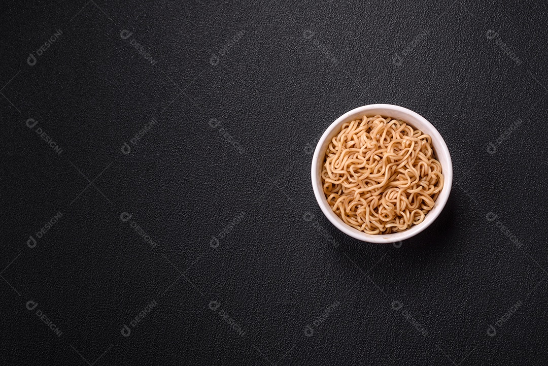 Macarrão de arroz de prato asiático com sal e especiarias em fundo escuro de concreto