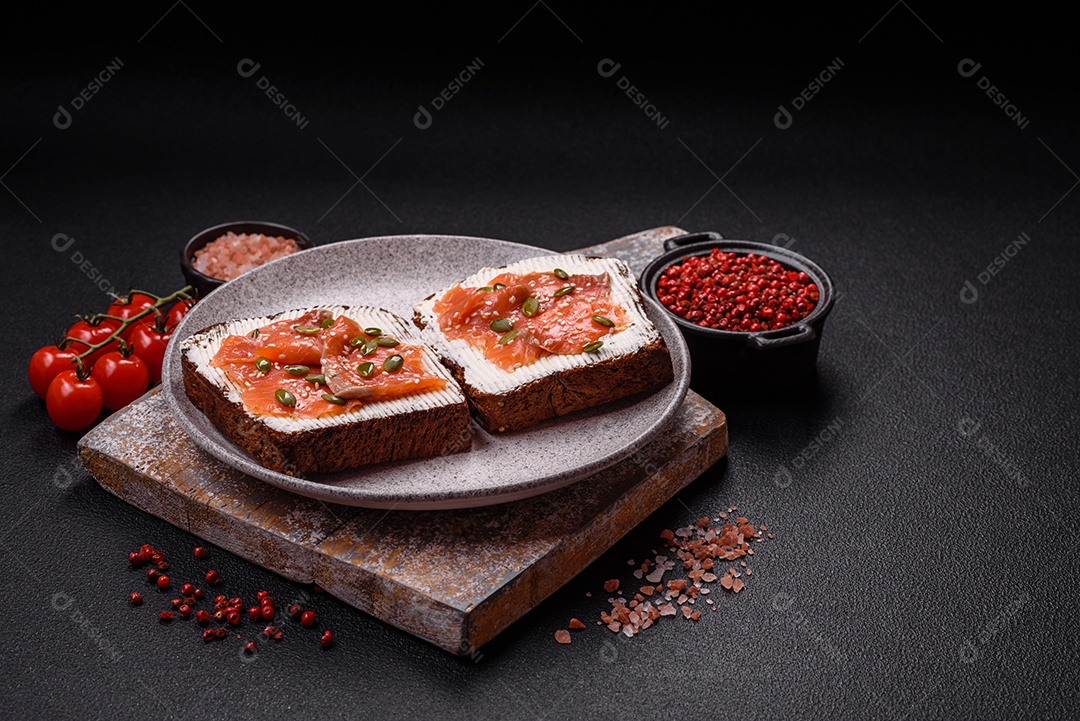 Torradas grelhadas com pasta de abacate, ovos, cream cheese, sal, especiarias e ervas sobre uma mesa de concreto texturizado