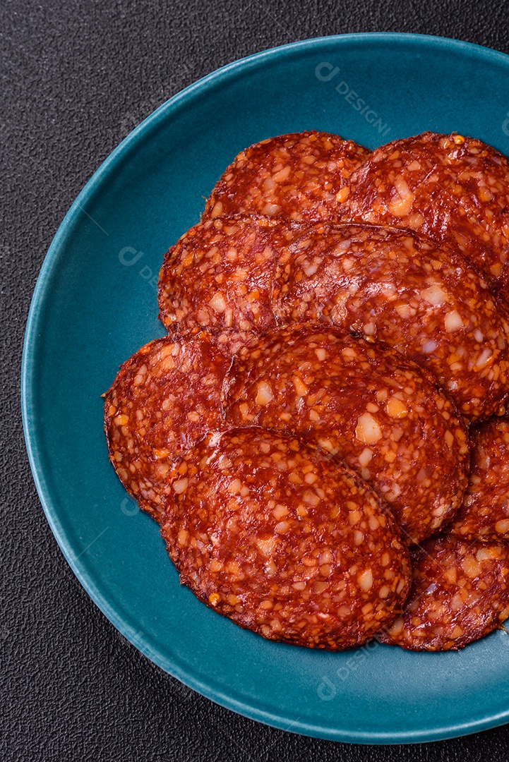 Salame defumado sobre uma tábua de madeira sobre mesa