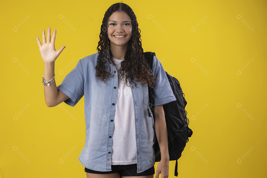 Jovem com camiseta jeans bolsa na costas e mão pra cima