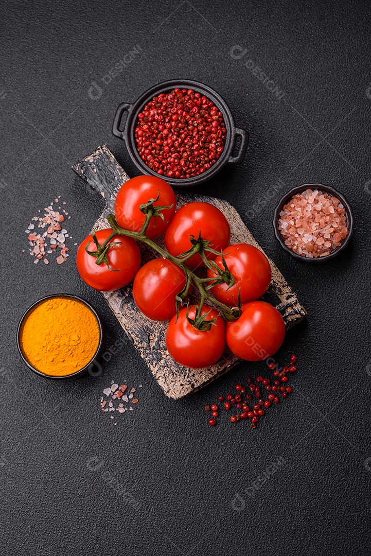 Tomates e temperos sobre tábua de madeira