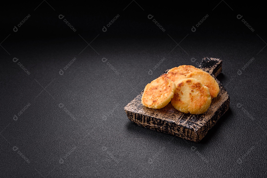 Minis panquecas de queijo doce deliciosas sobre tábua de madeira