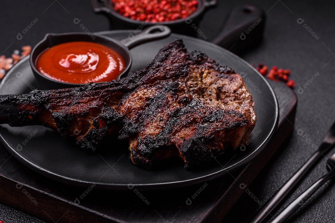 Bife fresco, suculento e delicioso em um fundo escuro. Prato de carne com especiarias e ervas