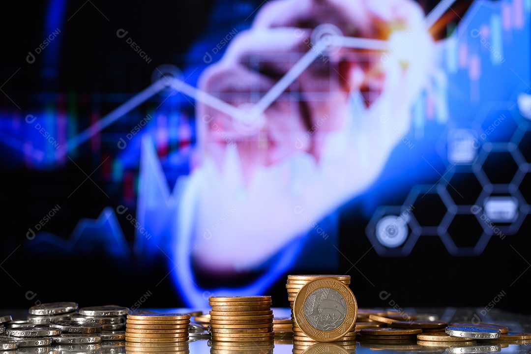 Moedas de um real empilhadas sobre uma mesa