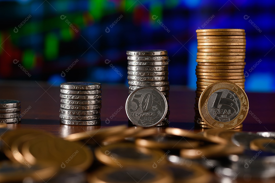 Several coins of fifty and a real stacked on a table