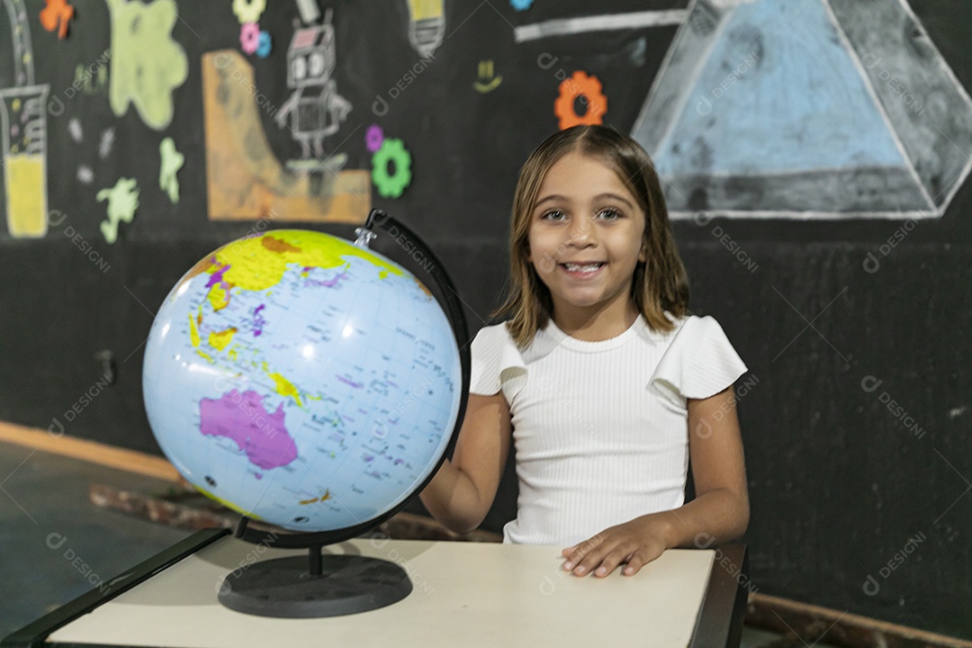 Happy girl with her studies on a world globe