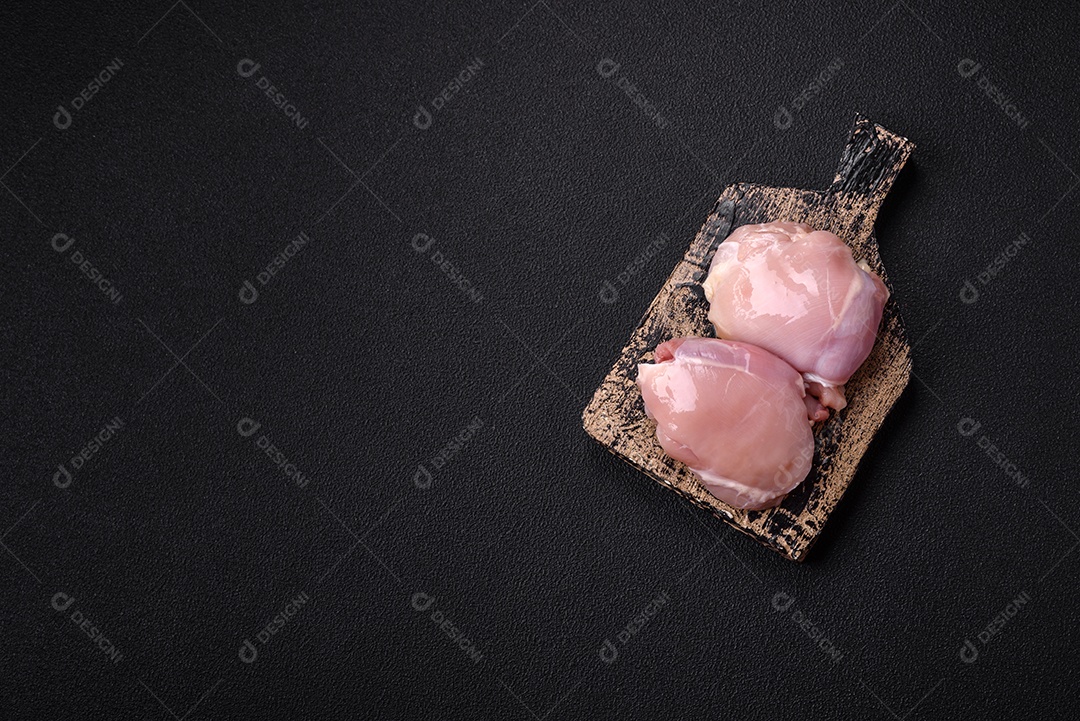 Filé de frangos frescos sobre tábua de madeira