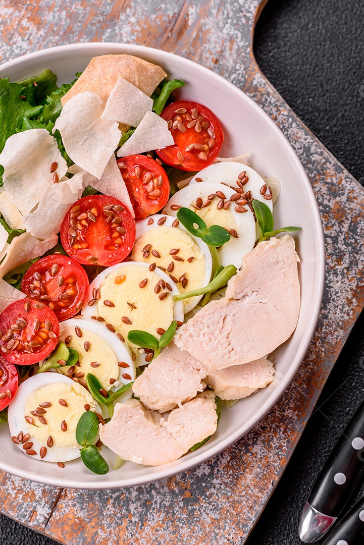 Deliciosa salada Caesar fresca em uma tigela com peito de frango e tomate