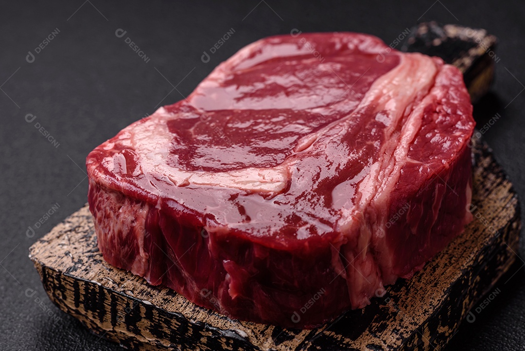 Bife cru em uma tábua de madeira