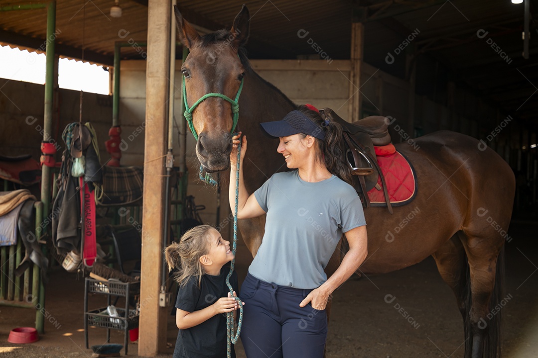 Coach horse and a little girl holding reins and happy