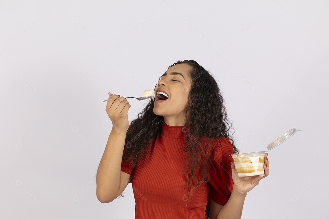Jovem se deliciando comendo bolo de pote