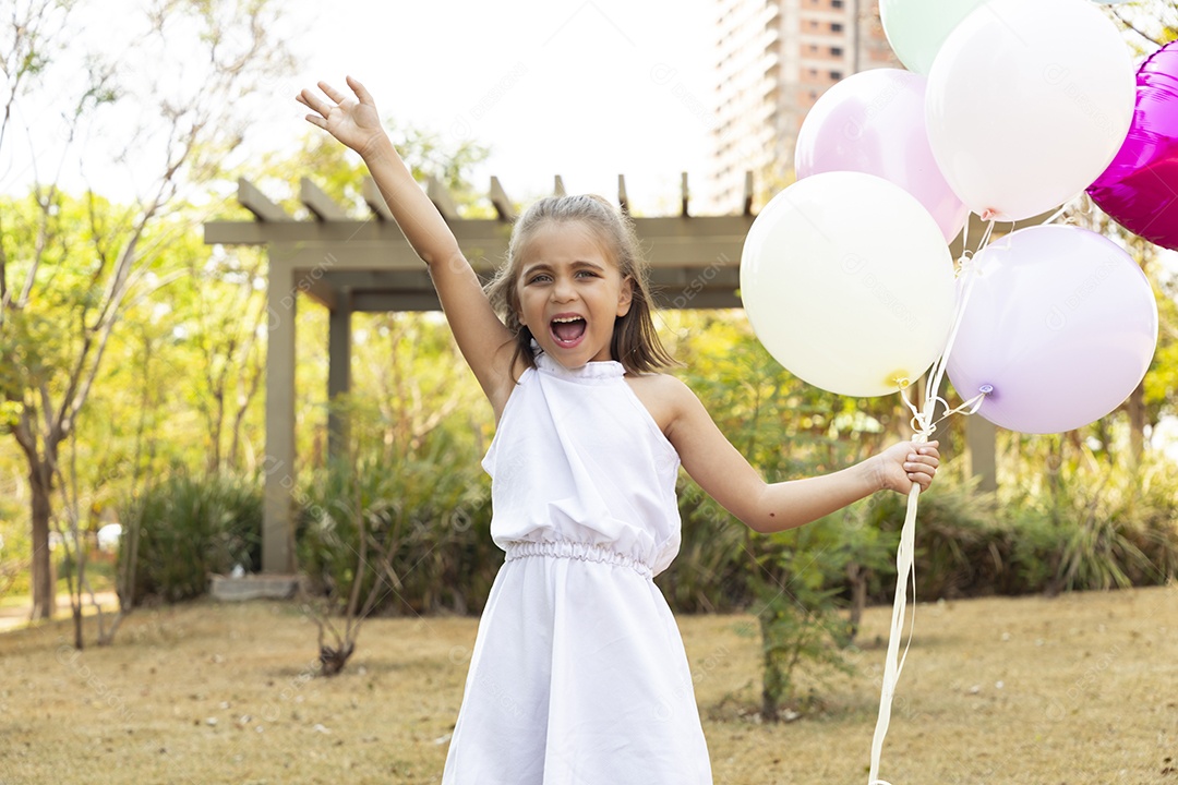 A cute girl celebrating with balloons in her hand
