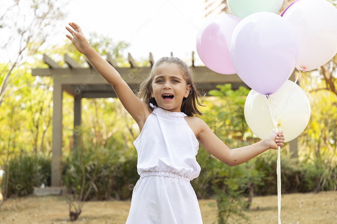 Menina fofa com mãos cheia de balões