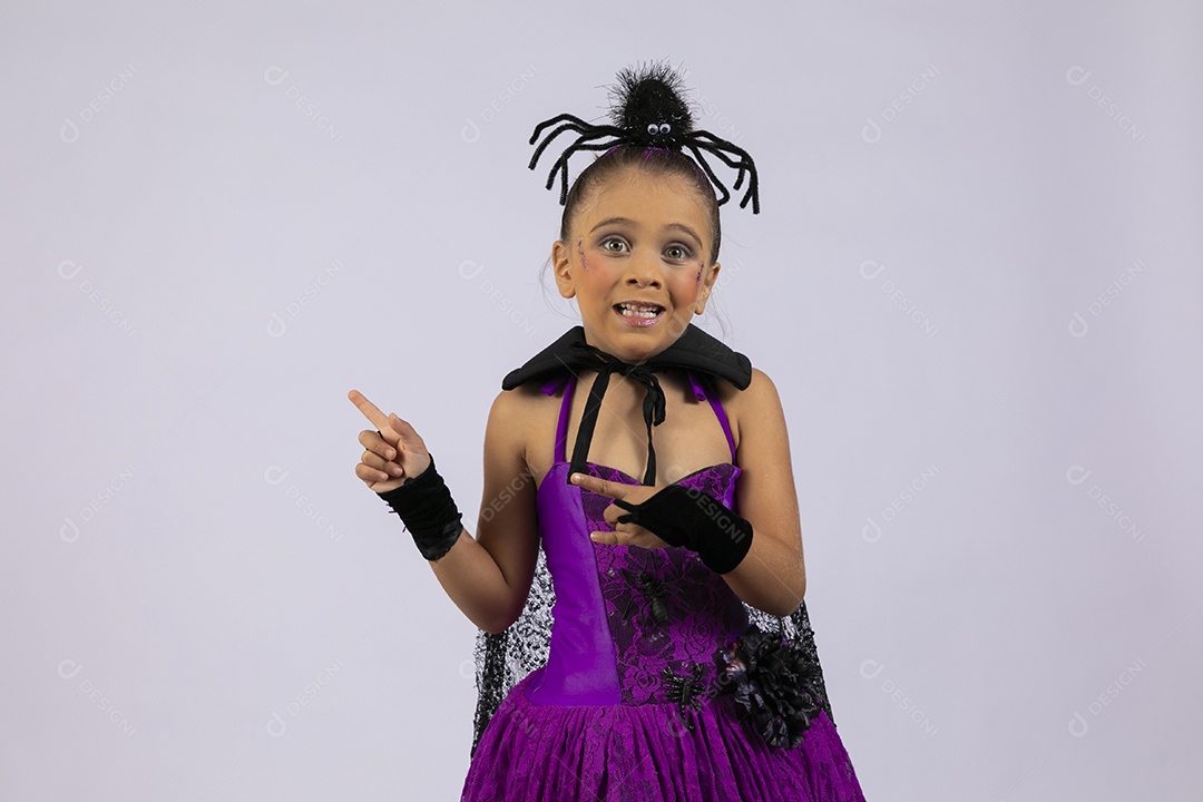 Menina fantasiada para halloween apontando para o lado