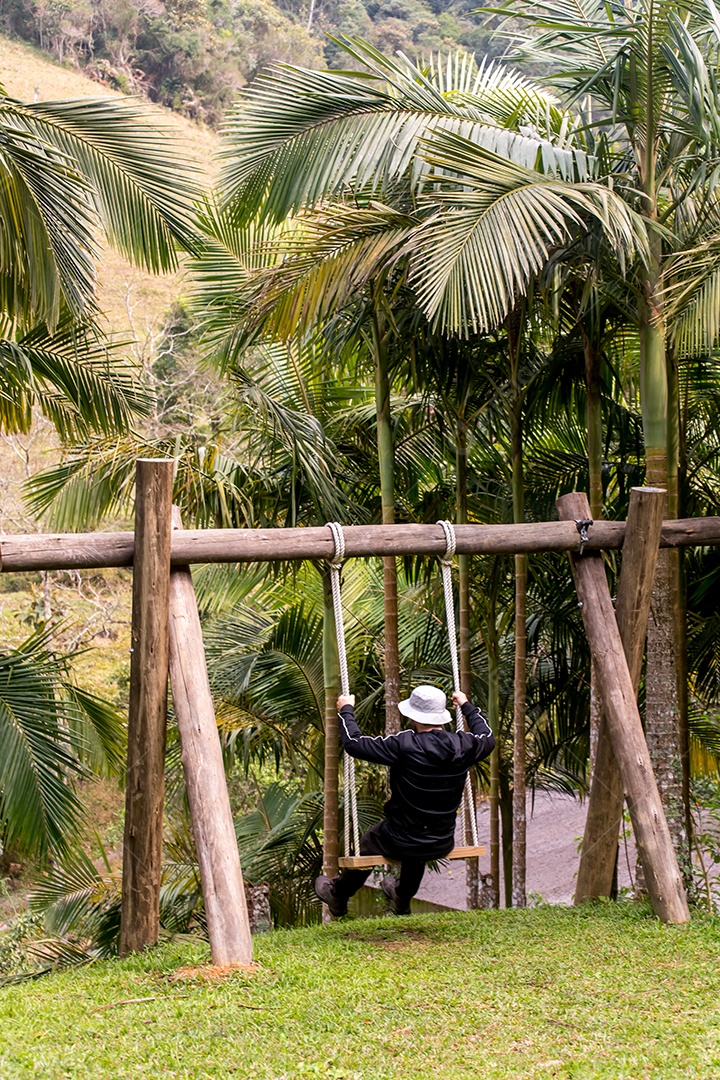 Homem balançando em balanço de madeira
