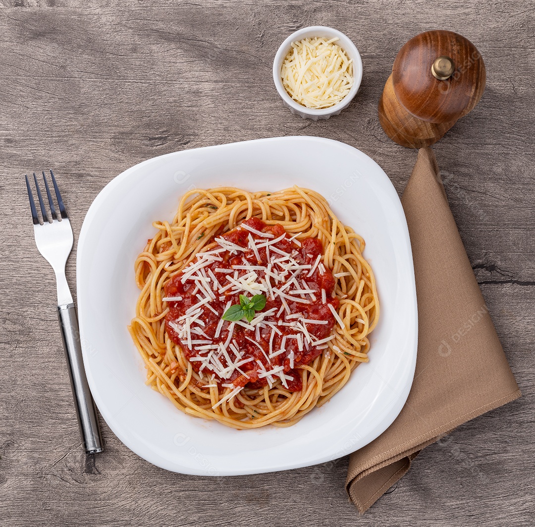 Macarrão espaguete em prato com molho de tomate e queijo parmesão