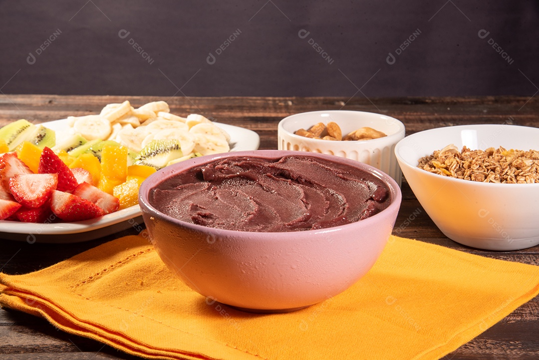 Brazilian açaí in bowl accompanied by tropical fruits