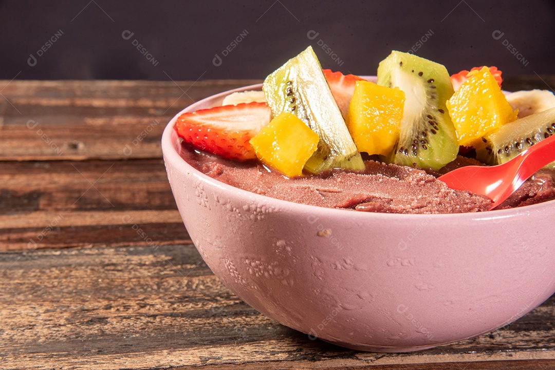 Brazilian açaí in bowl accompanied by tropical fruits