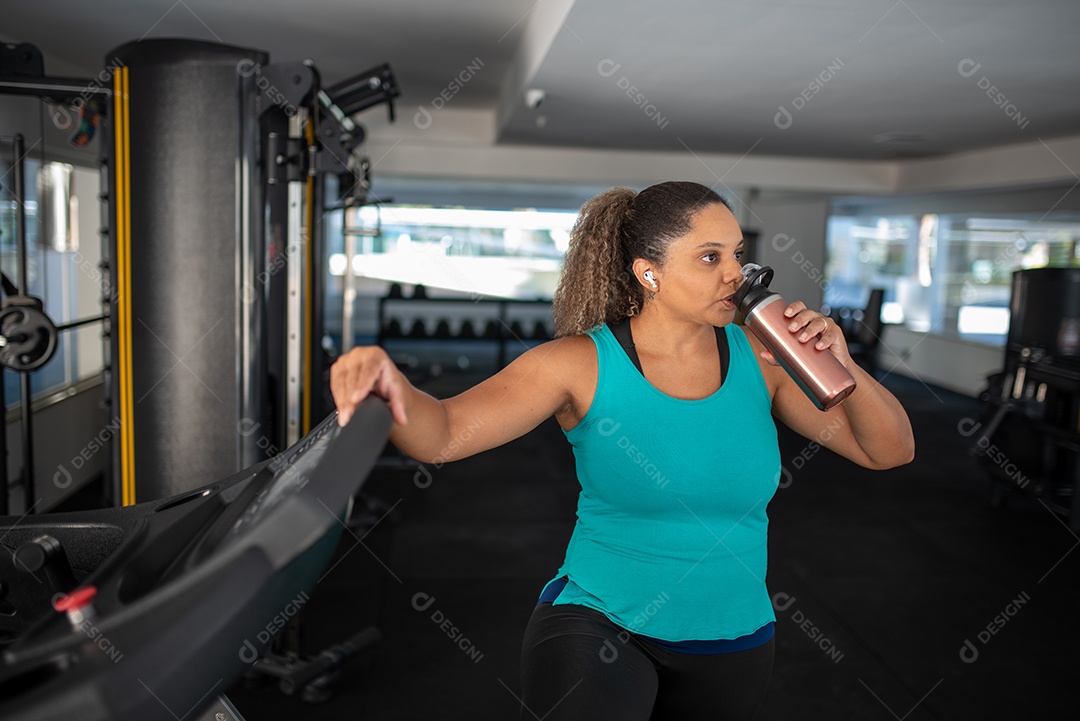 Sports woman working in multistation at the gym
