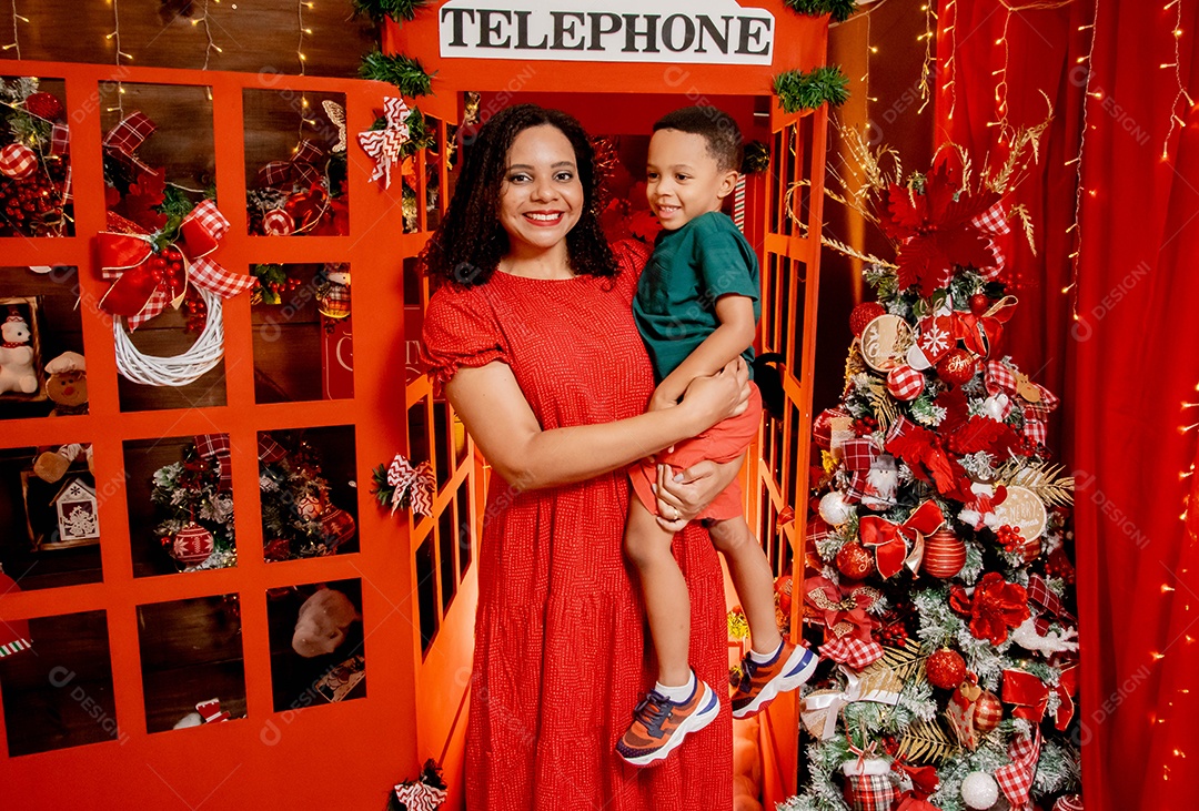 Mãe com seu filho no colo tirando foto natalina