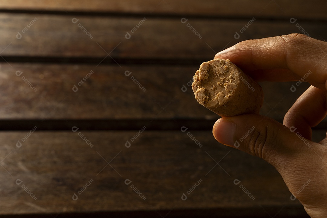 Paçoca na mão de uma pessoa