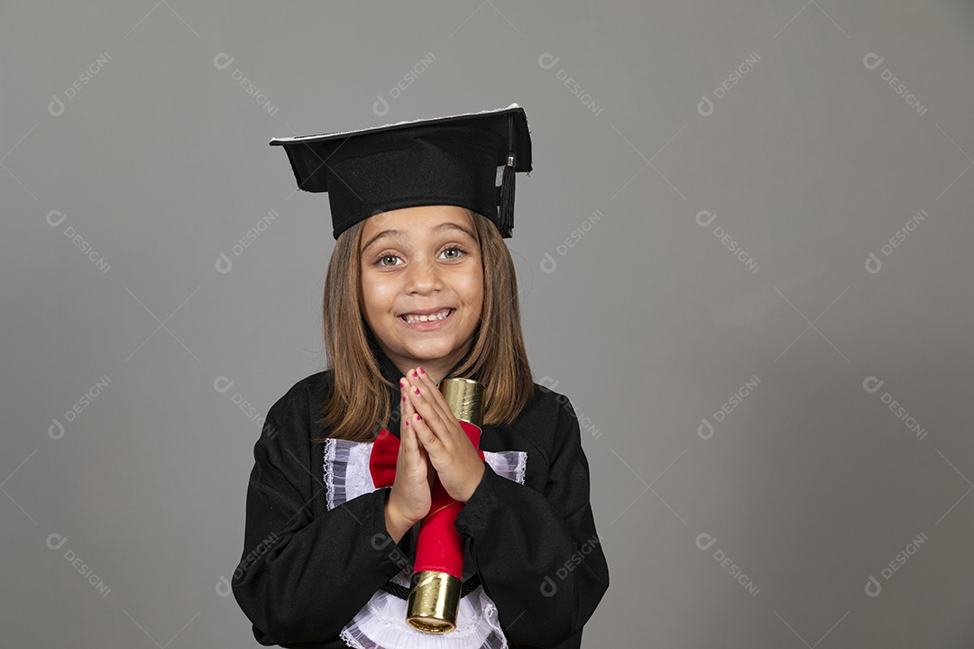Linda menina com mãos dada agradecendo usando beca de formatura