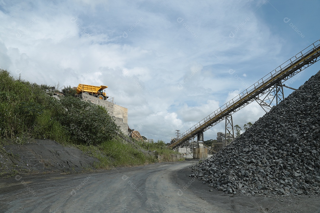 Monte de britas e um britador para serviço