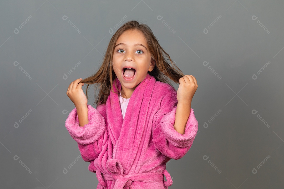 Linda menina usando roupão de banho rosa sobre fundo isolado