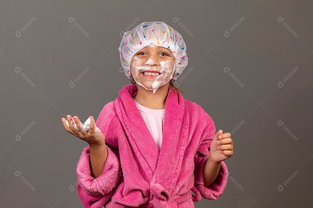 Linda menina usando roupão de banho rosa touca esfoliante sobre fundo isolado