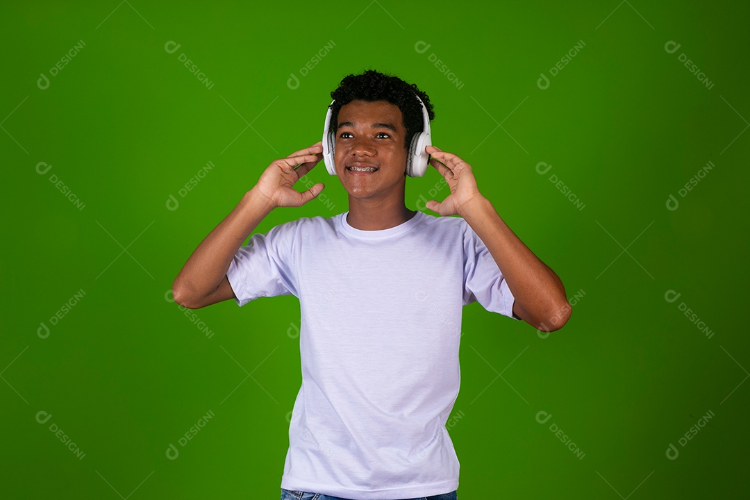 Lindo garoto negro usando fone de ouvido sobre fundo verde isolado