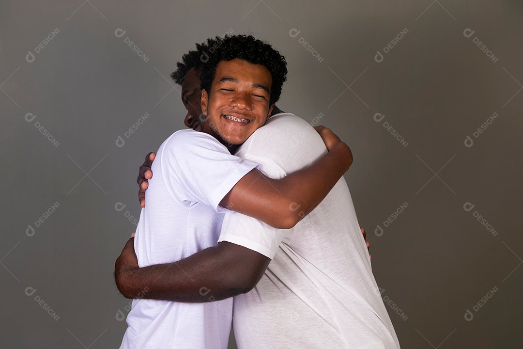 Lindo pai e filho se abraçando sorridentes sobre fundo isolado