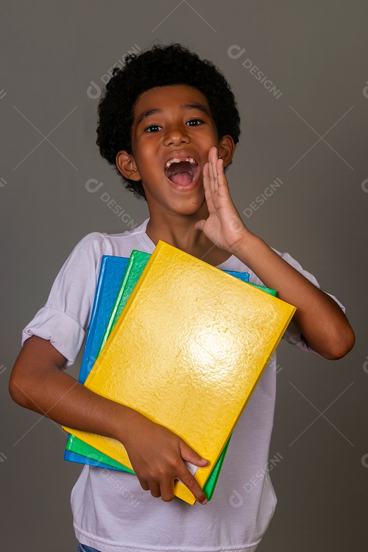 Lindo garoto negro sorridente segurando cadernos sobre fundo isolado