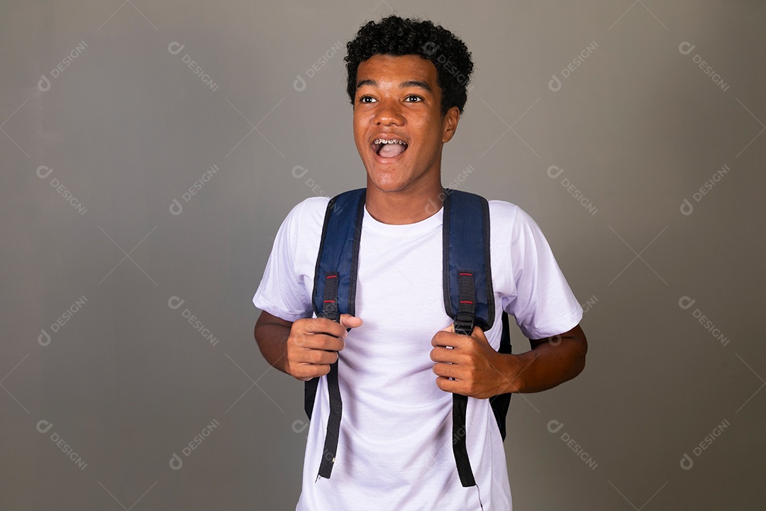 Lindo garoto negro sorridente usando bolsa sobre fundo isolado