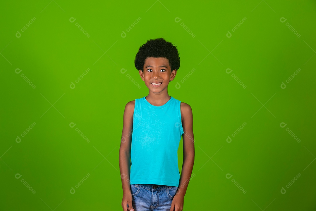 Lindo garoto negro sorridente de camisa azul sobre fundo verde isolado
