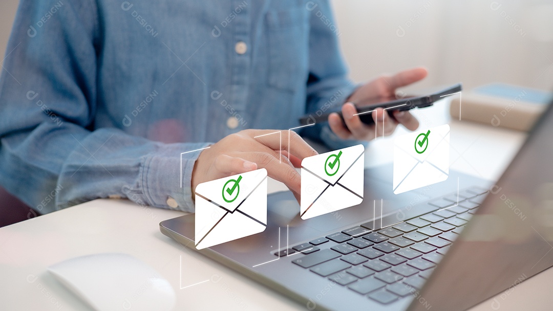 Mão de empresário mechendo em leptop e smartphone ao msm tempo sobre fundo desfocado