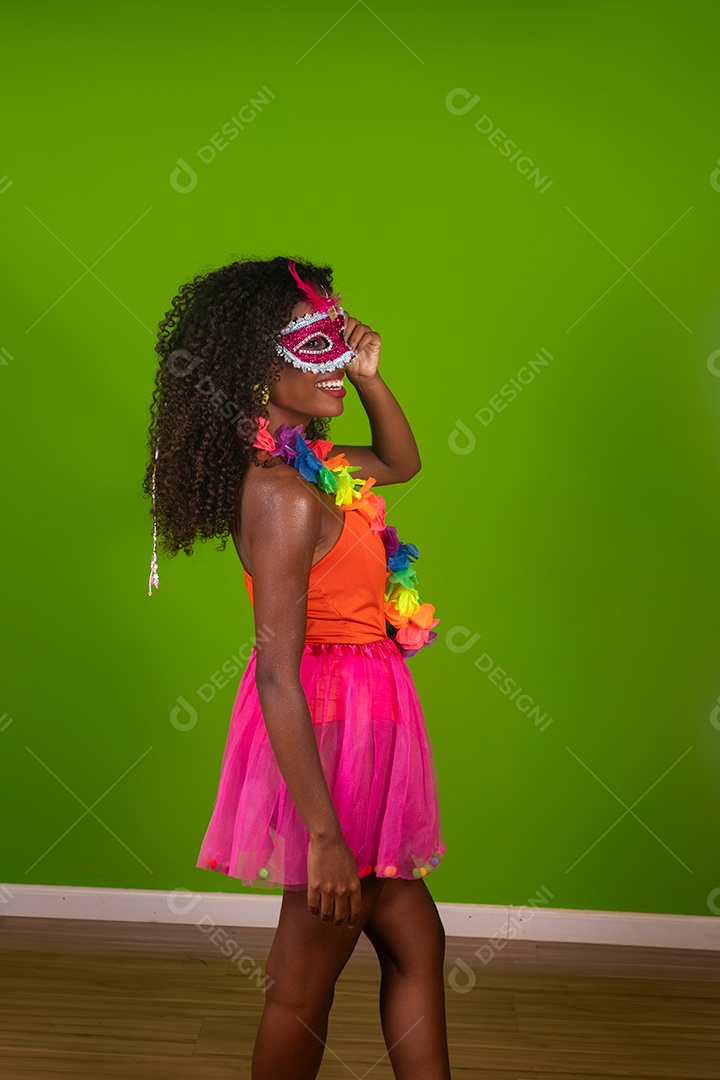 Linda morena do cabelo cacheado sorridente fantasiada sobre fundo verde isolado