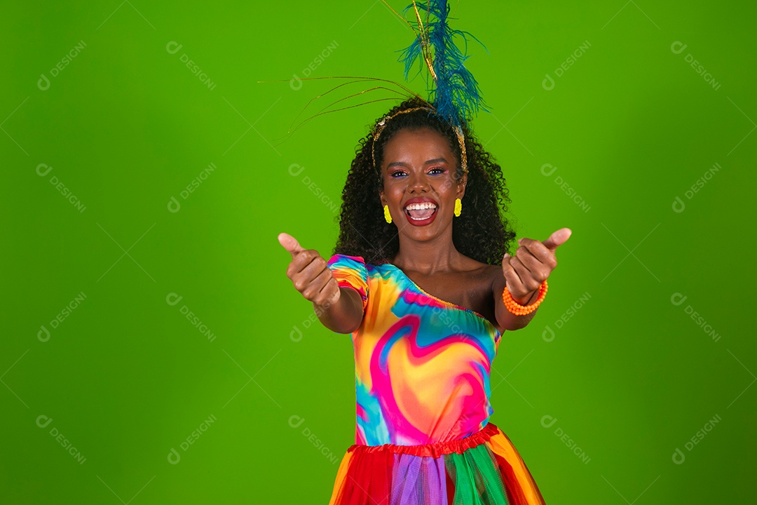 Linda morena do cabelo cacheado sorridente fantasiada sobre fundo verde isolado