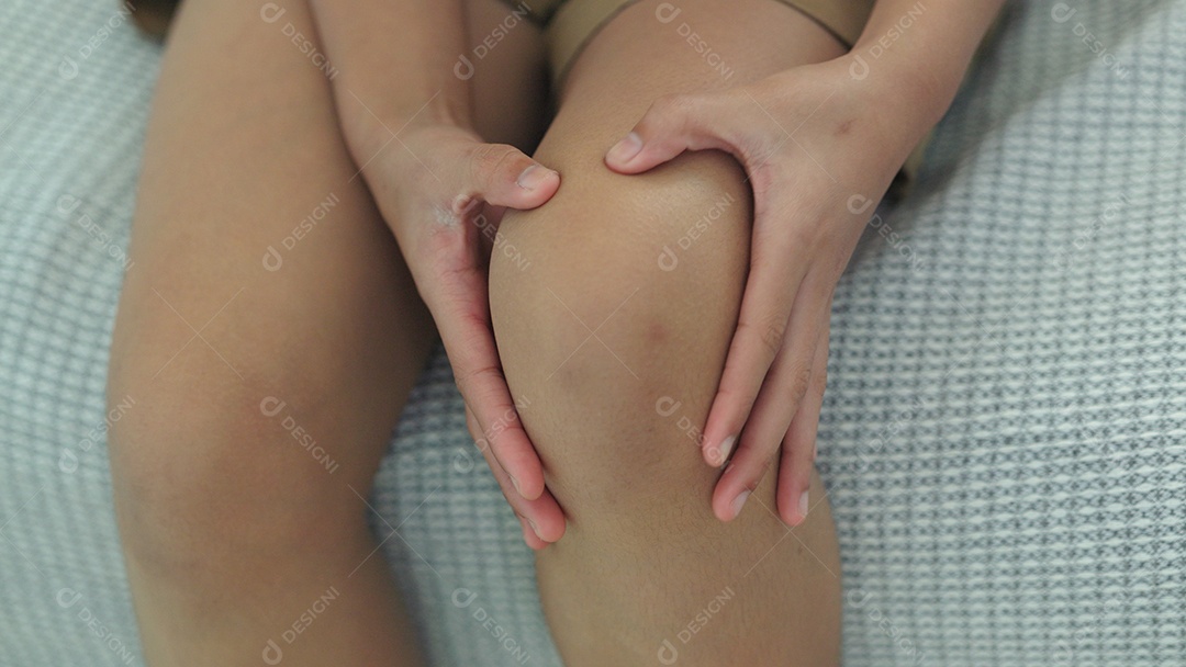 Mulher com dores nos joelhos e dores musculares devido síndrome da dor femoropatelar