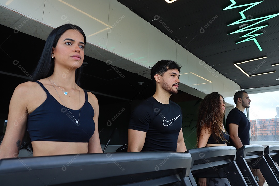 Lindas pessoas fazendo exercicíos sobre uma academia