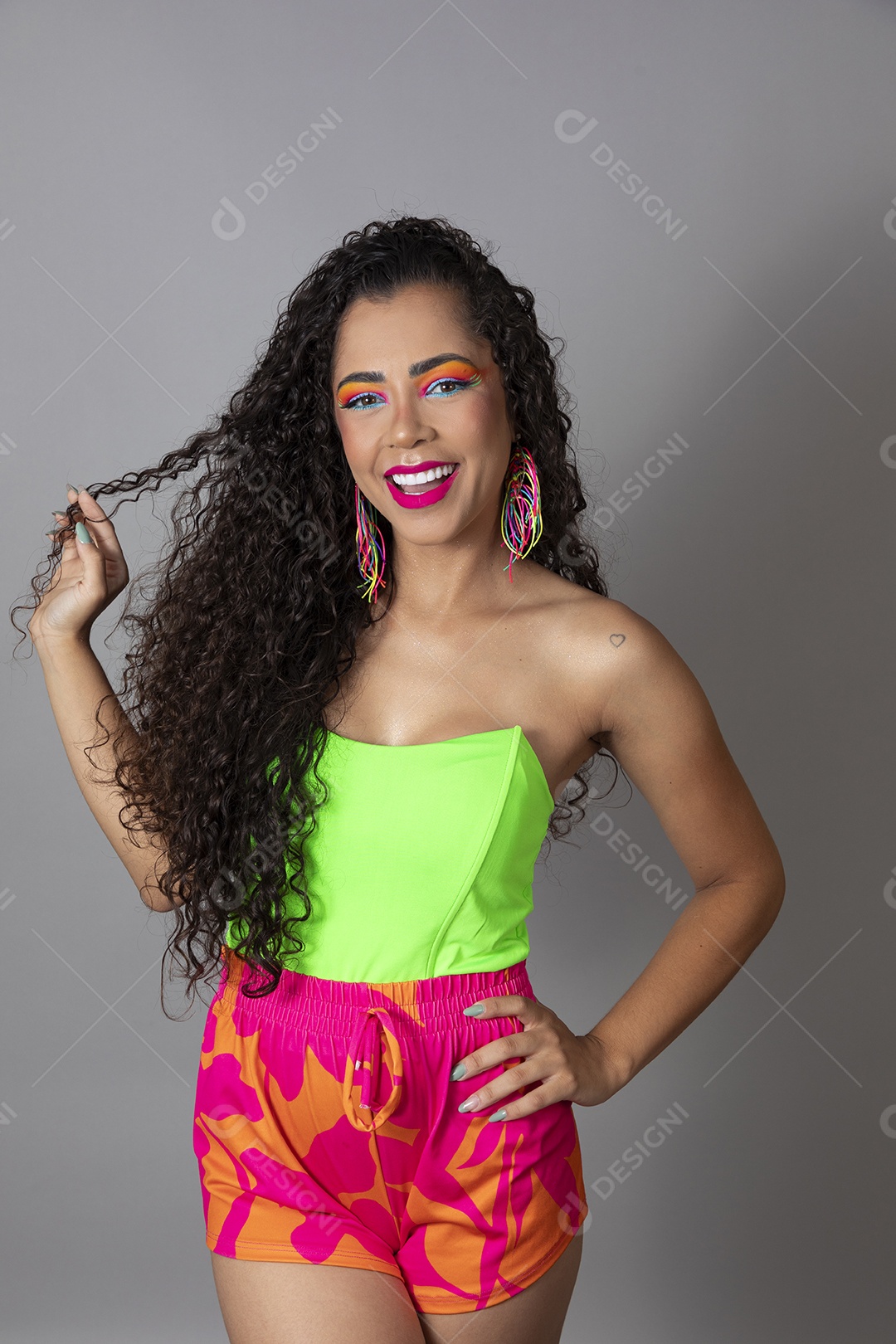 Linda morena do cabelo cacheado sorridente fantasiada sobre fundo isolado