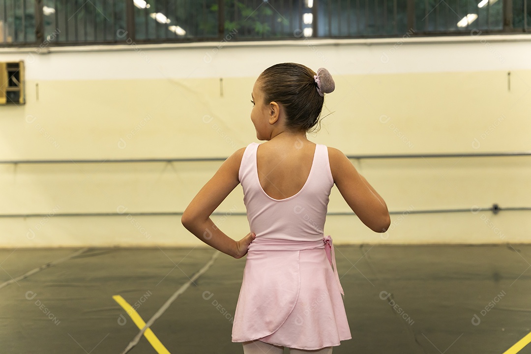 Linda menina sorridente praticando balé sobre escola de dança